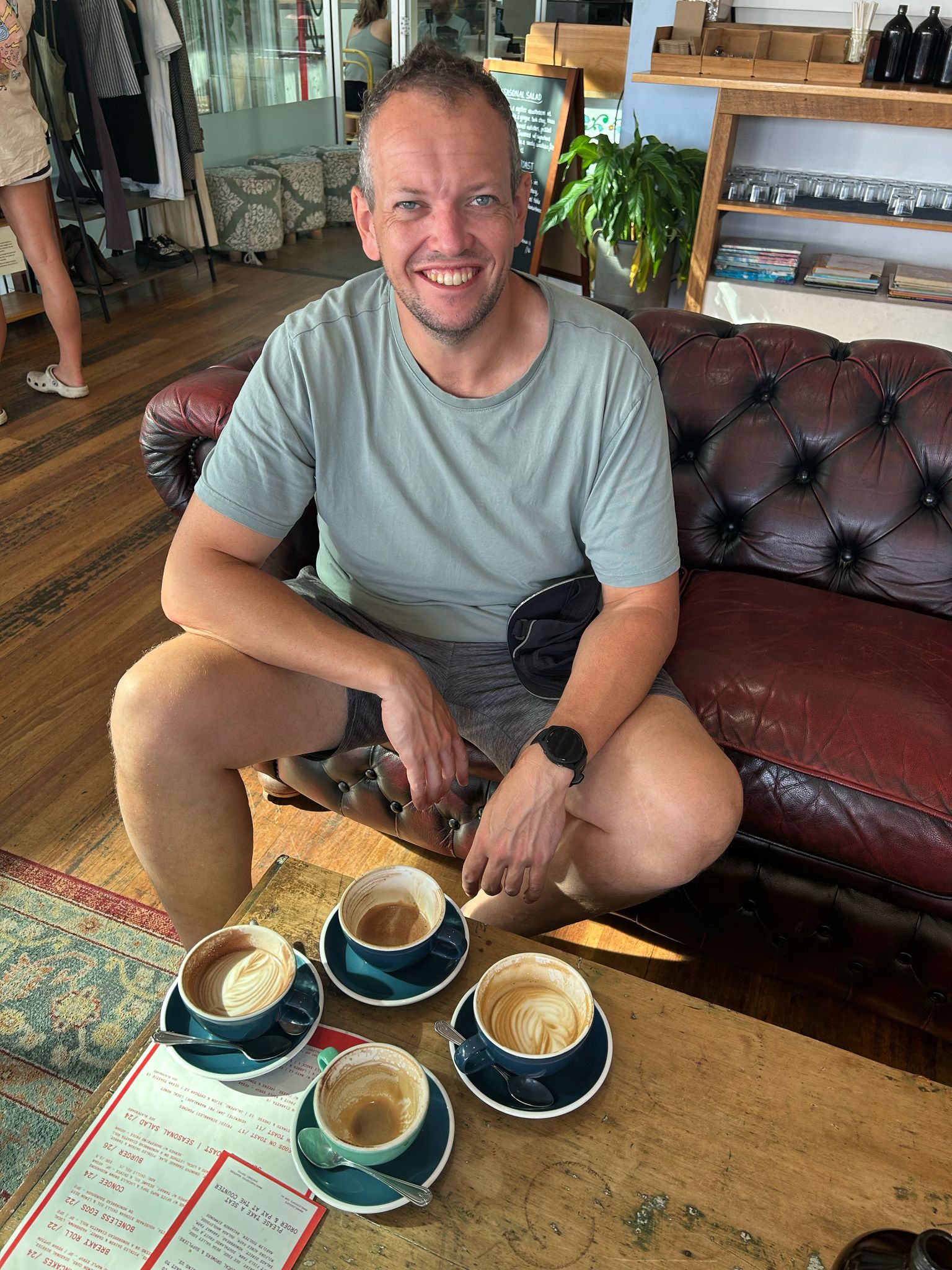 Four cups of coffee lined up on a table at Boneless Cafe