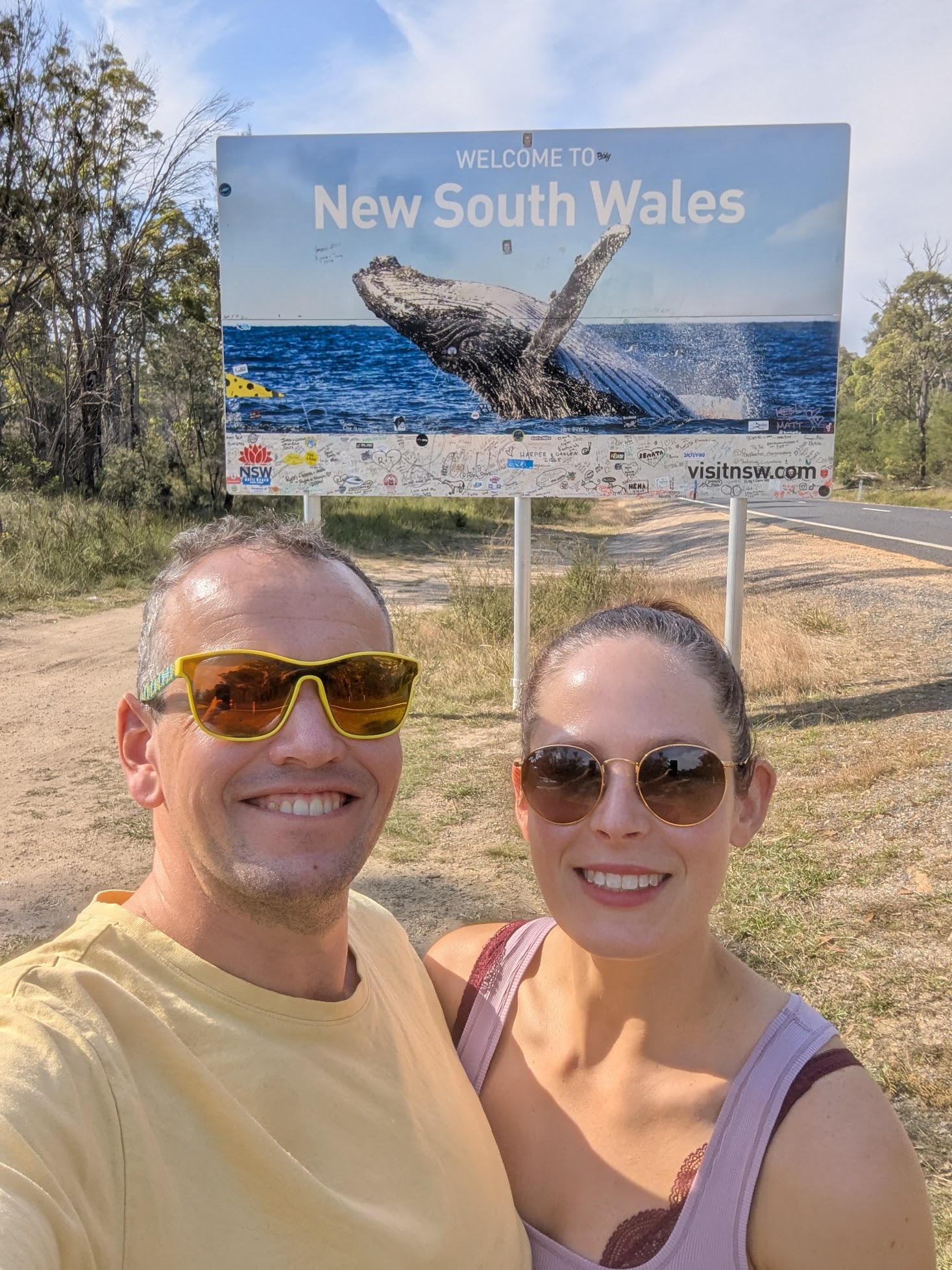 Kat and Brett at the border with Welcome to NSW sign